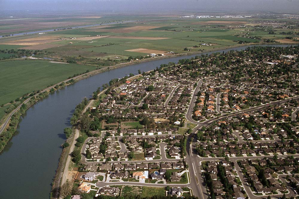 A levee with a city behind it.